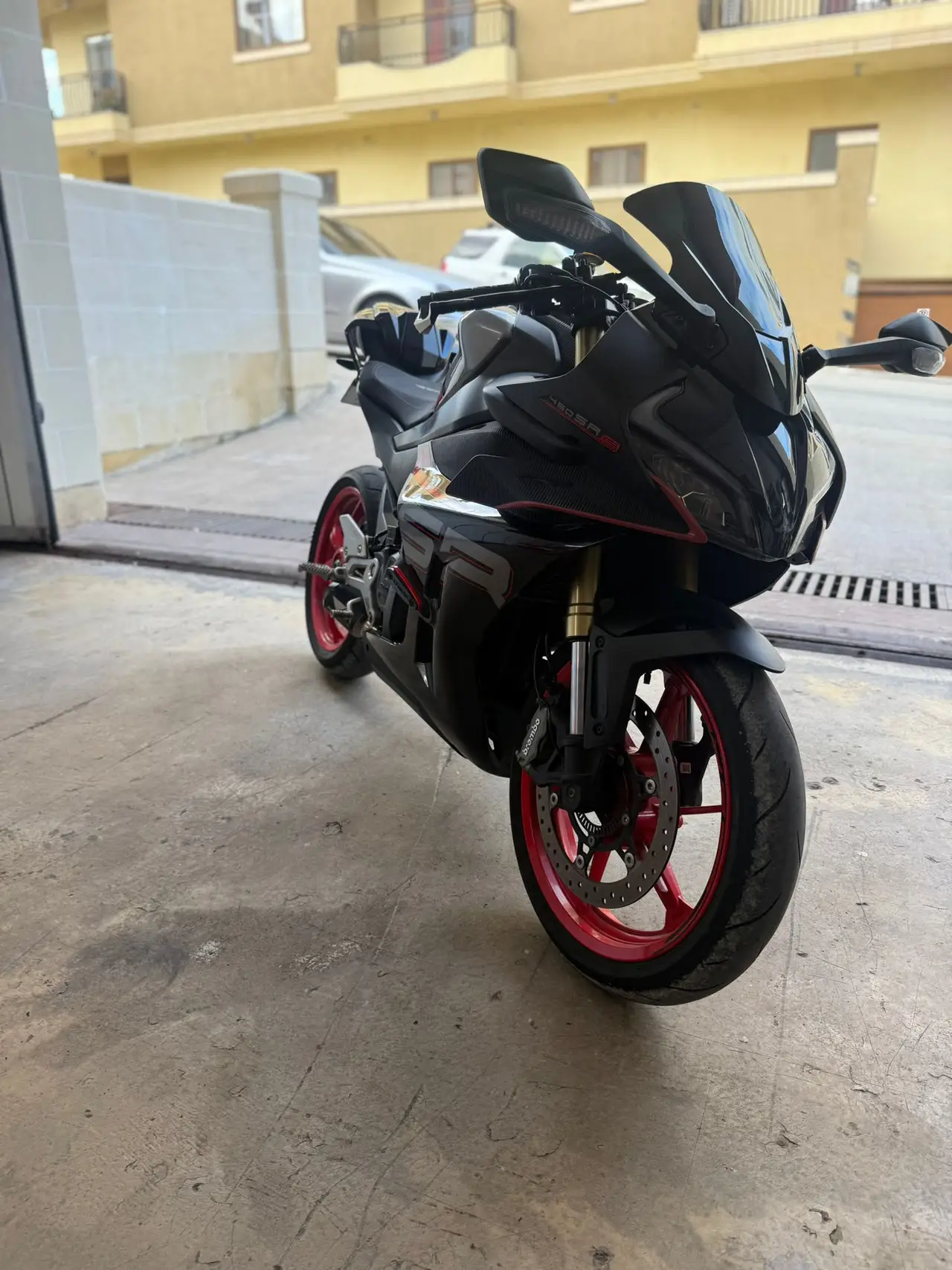 Black performance motorcycle with red wheels